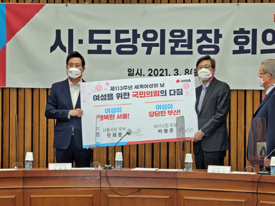 4.7 보궐선거에 출마한 국민의힘 오세훈 서울시장 후보(왼쪽 세번째)와 박형준 부산시장 후보(오른쪽 세번째)가 8일 오전 서울 여의도 국회에서 열린 국민의힘 시·도당위원장 회의에서 '세계여성의 날' 113주년 계기 여성을 위한 국민의힘의 다짐에 서명을 한뒤 기념촬영을 하고 있다.[사진=국민의힘 제공]